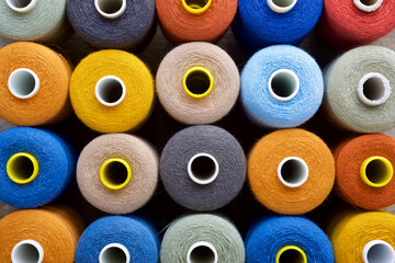 Close-up of multicolored sewing thread spools