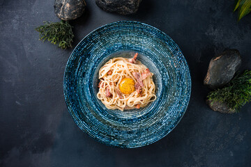 Obraz na płótnie Canvas Dinner spaghetti pasta with bacon, egg, cream sauce and spices.