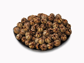 Pride of India dry seeds (Lagerstroemia speciosa) in a bowl isolated on white background, other common names :  Queen’s Flower, Queen’s Crape Myrtle.