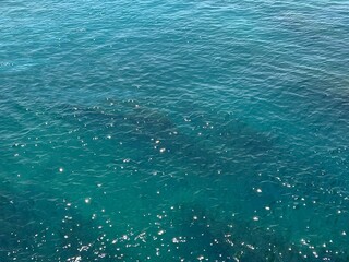 Shiny blue water in the sea, aerial view.