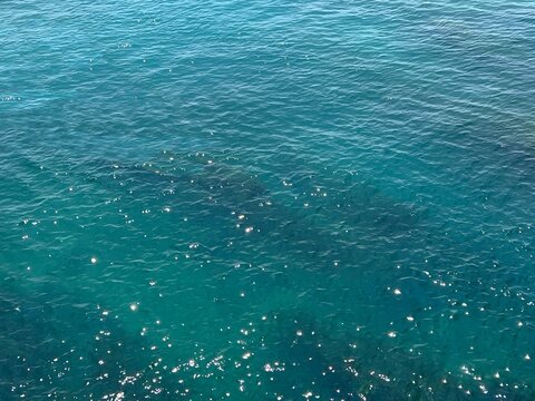Shiny blue water in the sea, aerial view.