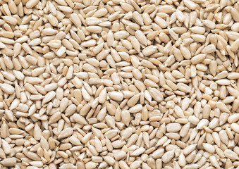 Healthy peeled sunflower seeds top view macro background.Healthy snack.