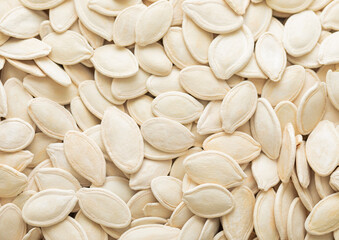 Raw white salted pumpkin seeds top view macro background.Healthy snack.