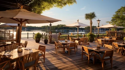 Papier Peint photo Descente vers la plage A riverside restaurant patio with wooden boardwalks and nautical decor