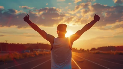 Poster Successful man raising arms after cross track running on summer sunset. Fitness male athlete with arms up celebrating success and goals after sport exercising and working out. © buraratn
