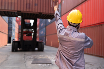 Asia logistic engineer man worker or foreman working direct driver forklift container at container site	