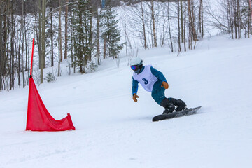 Athlete on a snowboarding slalom