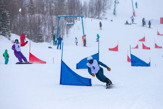 Athletes on a snowboarding slalom