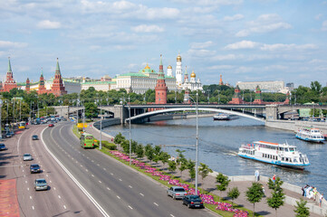 Fototapeta na wymiar Picturesque view of the center of Moscow, the Kremlin, summer. Bridge over the Moscow River, pleasure boats with passengers on board.