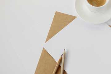 Obraz na płótnie Canvas Minimal Business Workplace with Blank Paper Sheets and Graphite Pencils, Cup of Coffee. Freelance Designer. New Project Concept.