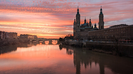 Flashes of Passion: The City of Zaragoza Bathed by the Red Sunset, Embracing the Basilica of the...