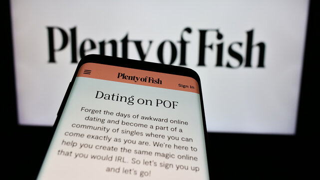 Stuttgart, Germany - 02-26-2024: Mobile phone with website of Canadian online dating company Plentyoffish Media ULC in front of business logo. Focus on top-left of phone display.