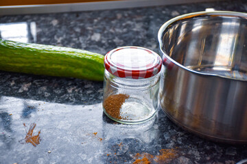Mess on the kitchen counter, cucumber, coffee, pot