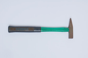 A small green steel hammer with a black plastic handle on a white background