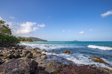Fototapeta na wymiar Nature in a special landscape. A rocky coast by the sea. Great landscape shot of cliffs in the Caribbean, the waves breaking against the island of Guadeloupe in the French Antilles.