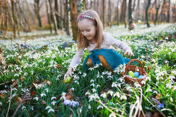 Five year old girl playing egg hunt on Easter