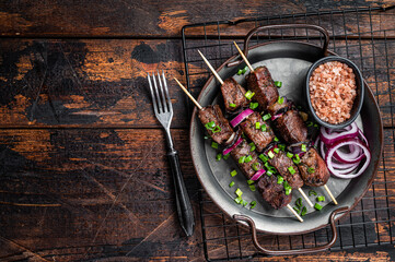 Kebabs grilled meat skewers, shish kebab with onion and herbs, grilled beef meat. Wooden...