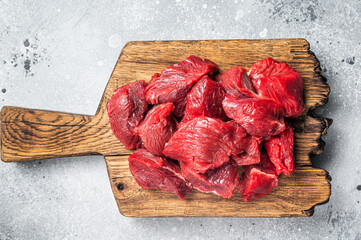 Raw organic diced lamb meat for cooking Goulash. Gray background. Top view