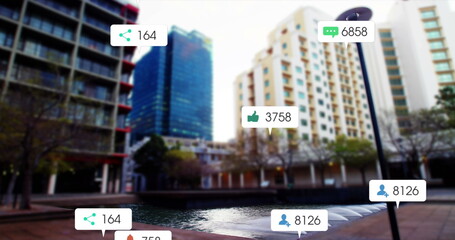 Image of social media icons and numbers on white banners over cityscape