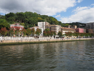 Fototapeta na wymiar Mansions at Nervion river in European Bilbao city in Spain