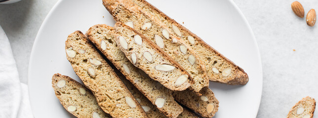 almond biscotti on a white plate, almond cantucci cookies on a white plate, flatlay of biscotti...