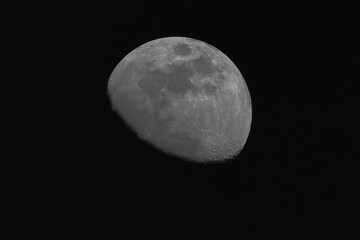 Half moon on black sky background on night time.Moon texture.