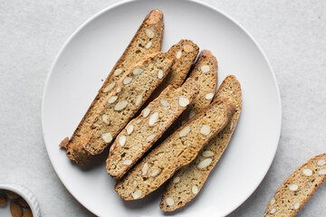 almond biscotti on a white plate, almond cantucci cookies on a white plate, flatlay of biscotti cookies or twice baked cookies