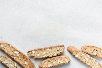 almond biscotti on white parchment lined tray, almond cantucci cookies on a white board, flatlay of...