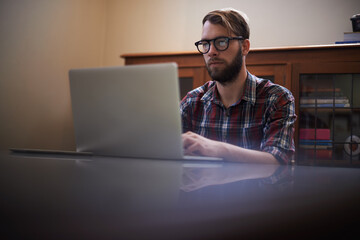 Man, laptop and journalist with glasses in remote work, communication or networking at home. Male...