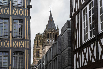 Facade of half-timbered houses in the city of Rouen in France, acev its church