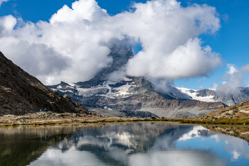 Panoramic view over the water of the Riffelsee near Zermatt, Switzerland towards the Matterhorn...