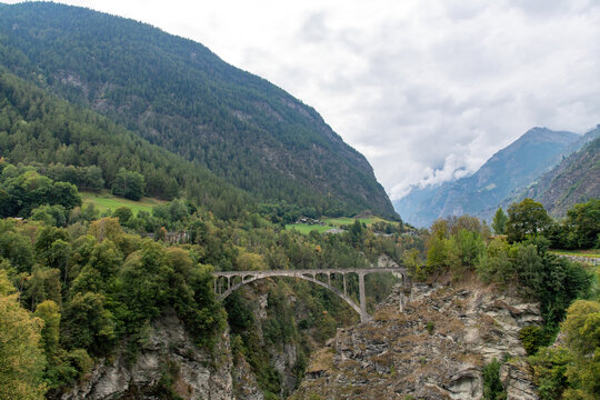 Panoramic view over the Stalden, Switzerland landscape with the 1930, 108 meters long Visp or Stalden bridge from bridge designer, A. Sarrasin crossing a gorge in the Valais region 