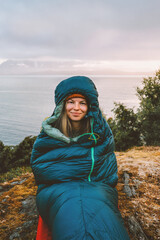 Woman in sleeping bag bivouac outdoor camping gear girl hiking in mountains active travel vacations, tourist girl traveling in Norway active adventure healthy lifestyle hobby sustainable tourism - 749358623