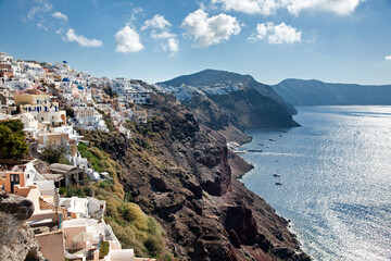 On top of the cliffs of Santorini in Greece lies the town of Oia, known for its white houses. Many cruise ships visit this island making it a tourist attraction.
