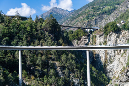 Low angle view over the Stalden, Switzerland landscape with in back the 1959 Killerhof Bridge or Illas Brigga from bridge designer, A. Sarrasin and in front 2019 completed modern Chinegga bridge