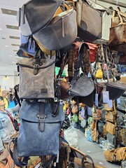 roadside hawker stall with different size purse and bags hanging