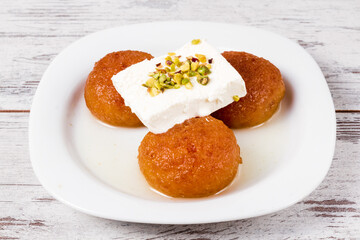 Delicious Turkish Dessert, Kemalpasha, Topped with Cream and Pistachios