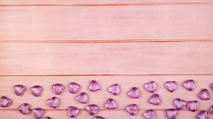 Wooden background with hearts for valentine's day. Beautiful wrapping paper or background for a postcard. Place for text, banner for website