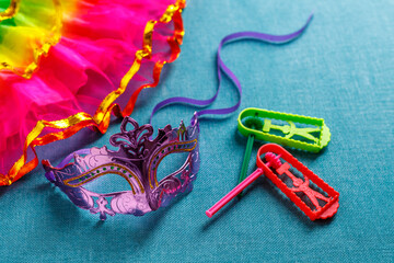 Beautiful white and multicolor carnival masks on a blue background. Purim, Mardi Gras. Top view