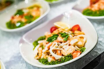 Seafood salad plates displayed in a restaurant refrigerator