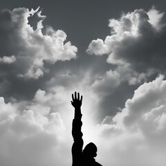 Two hands silhouettes reaching to the sky reaching the clouds 