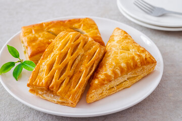 Baked puff pastry on white plate