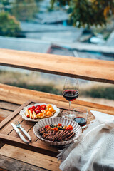 Vibrant red chili peppers and assorted spices in a wooden bowl, a fresh and healthy addition to your kitchen ingredients, showcasing organic and natural elements with a touch of greenery in a glass