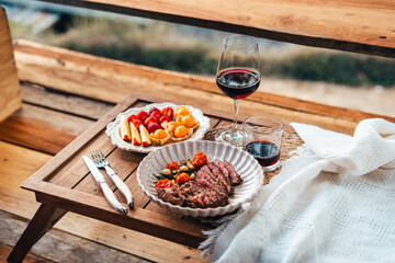 Vibrant red chili peppers and assorted spices in a wooden bowl, a fresh and healthy addition to your kitchen ingredients, showcasing organic and natural elements with a touch of greenery in a glass