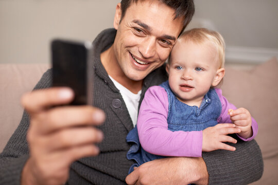Happy family, father and baby with selfie in home, love and care of new parent in living room. Dad, daughter and smile with cellphone for profile picture, cute and bonding together on sofa in house