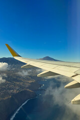 View from the wing of an airplane as we fly over Tenerife. Canary Islands. Spain. In the background the Pico Teide, the highest peak in Spain