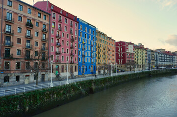 Buildings of various colors, on the bank of the Nervion River. Bilbao. Euzkadi. Spain
