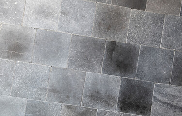 Dark gray square tiles neatly assembled textured background surface suitable for graphic design...