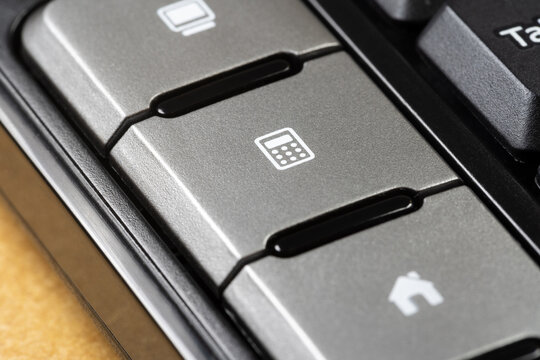 Close-up view showing the detail of a calculator shortcut key on a computer keyboard, doing calculations at work, accounting, spreadsheet editing simple abstract concept, object detail closeup, nobody
