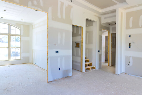 Plastering drywalling newly constructed house during construction phase